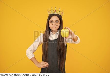 Teen Child In Queen Crown Hold Apple Isolated On Yellow Background. Princess Girl In Tiara. Teenage 