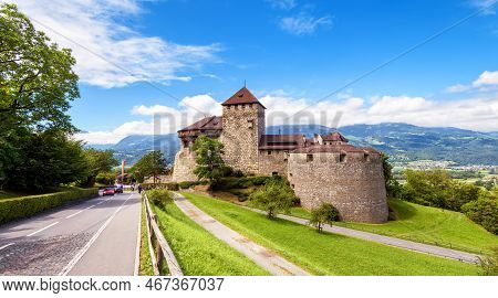 Vaduz Castle In Liechtenstein, Europe. Scenic View Of Royal Vaduz Castle, Road, Sky And Alps. Scener