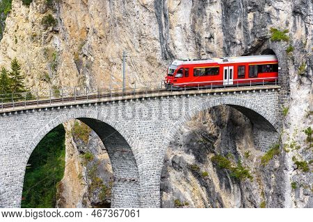 Bernina Express Glacier Train On Landwasser Viaduct, Filisur, Switzerland. View Of High Railroad Bri