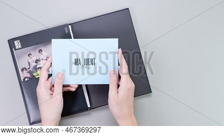 Hands Holding Stray Kids Maxident Mini Album Box Set On Grey. Pink Music Cd. South Korean Boy Band S