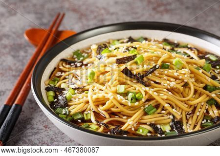 Korean Cold Noodle Soup Memil Guksu With Green Onions, Sesame And Seaweed Closeup In The Bowl On The