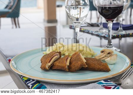 Stuffed Chicken Panne A La Carte Meal With Mushrooms And Mashed Potato At Restaurant Table Setting