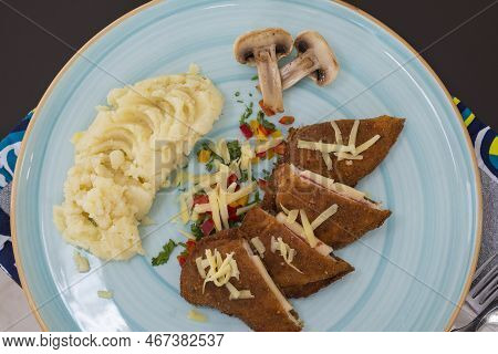 Stuffed Chicken Panne A La Carte Meal With Mushrooms And Mashed Potato At Restaurant Table Setting