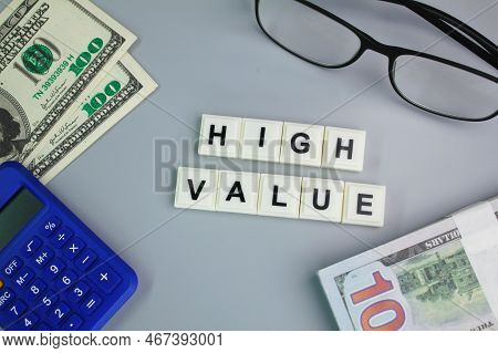 Paper Money, Calculator Glasses With The Word High Value. The Concept Of High Value Of A Valuable It