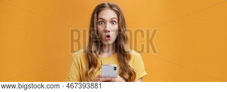 Close-up Shot Of Impressed Astonished Cute Young Girl With Makeup On And Natural Wavy Hair Folding L