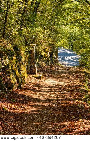 Talloires, France - September 08 2020 : An Historic Iron Cross On A Medieval Pillar Showing The Road