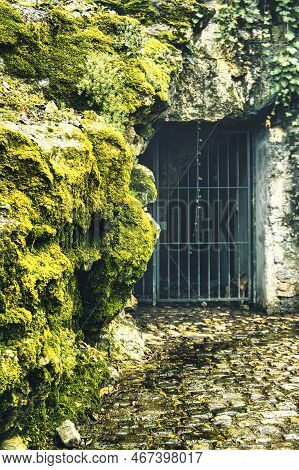 Menthon Saint Bernard, France - January 10 2020 : Mysterious Entrance Of A Cave In A Mountain With A