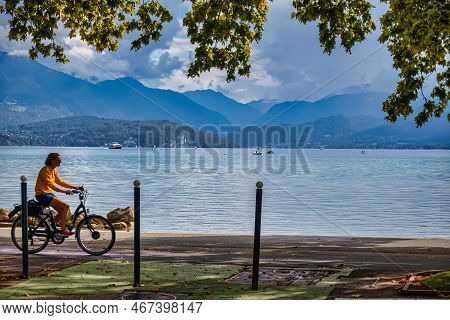 Annecy, France - September 21 2020 : Person On A Bicycle Is Riding A Long The Idyllic And Calm Lake 