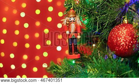 Christmas Decorations Hung On A Christmas Tree Against A Red Background.