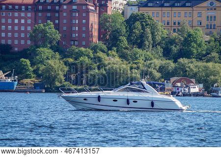 View Of Fast Boat In Sea Next To City