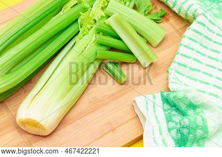 Fresh Celery Stem And Chopped Celery Sticks On Wooden Cutting Board. Vegan And Vegetarian Culture. R