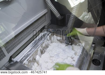 Mane Taking Out Models From White Polyamide Powder In Working Chamber Of 3d Printer, Cleaning And Re