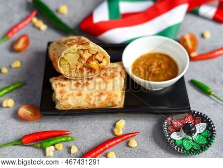 Vegetarian Mexican Burrito With Potato, Tofu,rice Served With Sauce Brracha
