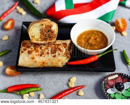 Mexican Burrito With Chorizo, Potato And Cheese Served With Sauce Barracha