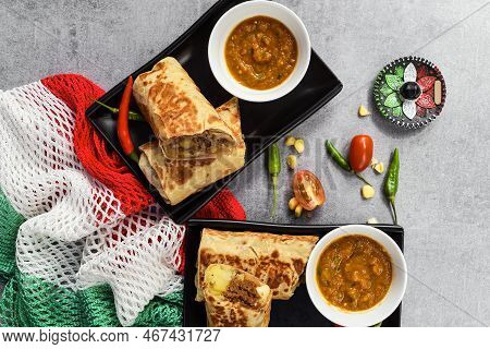 Mexican Burritos With Chorizo, Potato, Cheese And Beef Served With Sauce Borracha