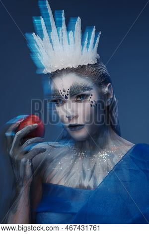 Ice Queen With Red Apple Against Blue Background