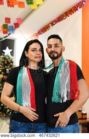 Mexican Married Couple Standing Against Christmas Tree