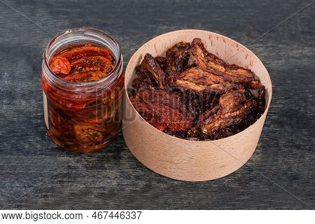 Dry-cured Red Tomatoes In The Round Wooden Box And Sun-dried Tomatoes Preserved In Cooking Oil With 