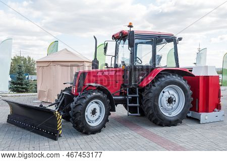 Red Wheeled Tractor With Mouldboard At An Agricultural Fair