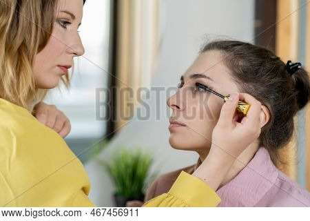 Beauty Stylist Applying Make-up To A Young Model.professional Make-up Artist Doing Glamour