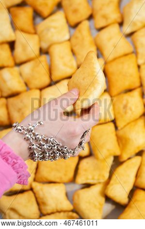 A Woman's Hand In A National Kazakh Decoration Holds A Baursak On Nauryz.