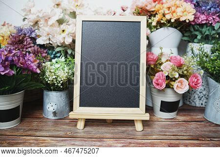 Empty Easel Chalkboard Sign Mockup With Flowers Decoration