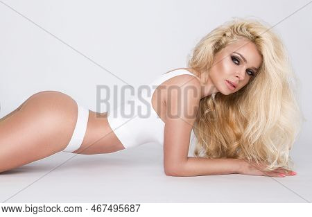 Beautiful Woman In White Lingerie On A White Background. Underwear Fashion Model.