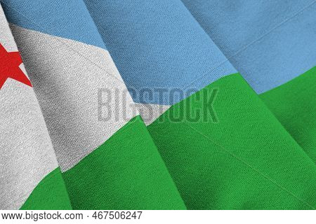 Djibouti Flag With Big Folds Waving Close Up Under The Studio Light Indoors. The Official Symbols An