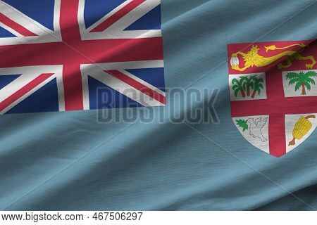 Fiji Flag With Big Folds Waving Close Up Under The Studio Light Indoors. The Official Symbols And Co