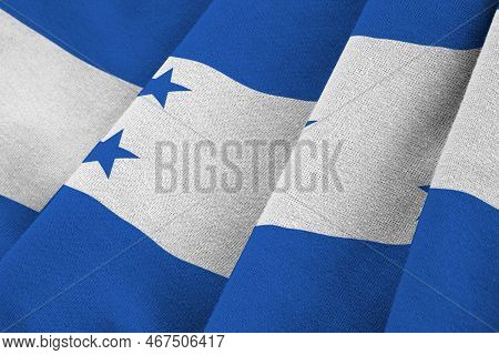 Honduras Flag With Big Folds Waving Close Up Under The Studio Light Indoors. The Official Symbols An