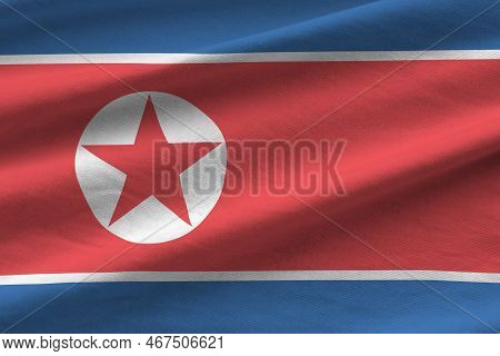 North Korea Flag With Big Folds Waving Close Up Under The Studio Light Indoors. The Official Symbols