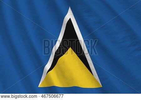 Saint Lucia Flag With Big Folds Waving Close Up Under The Studio Light Indoors. The Official Symbols