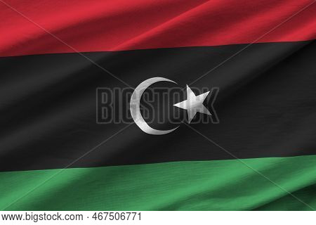 Libya Flag With Big Folds Waving Close Up Under The Studio Light Indoors. The Official Symbols And C
