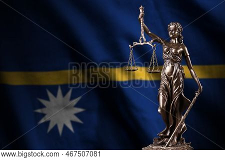 Nauru Flag With Statue Of Lady Justice And Judicial Scales In Dark Room. Concept Of Judgement And Pu