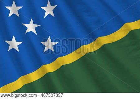 Solomon Islands Flag With Big Folds Waving Close Up Under The Studio Light Indoors. The Official Sym