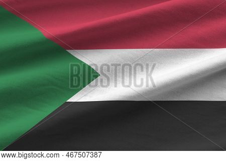 Sudan Flag With Big Folds Waving Close Up Under The Studio Light Indoors. The Official Symbols And C