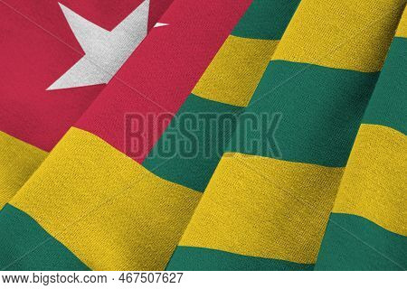 Togo Flag With Big Folds Waving Close Up Under The Studio Light Indoors. The Official Symbols And Co