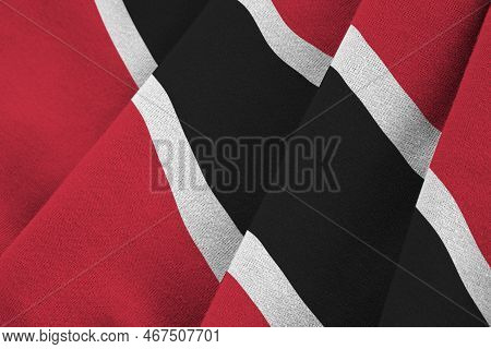 Trinidad And Tobago Flag With Big Folds Waving Close Up Under The Studio Light Indoors. The Official