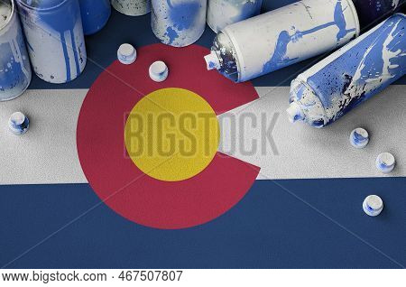 Colorado Us State Flag And Few Used Aerosol Spray Cans For Graffiti Painting. Street Art Culture Con