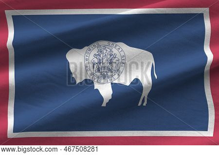 Wyoming Us State Flag With Big Folds Waving Close Up Under The Studio Light Indoors. The Official Sy