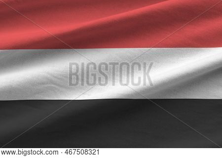 Yemen Flag With Big Folds Waving Close Up Under The Studio Light Indoors. The Official Symbols And C