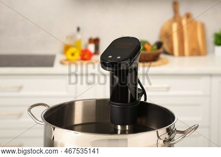 Pot With Sous Vide Cooker In Kitchen, Closeup. Thermal Immersion Circulator