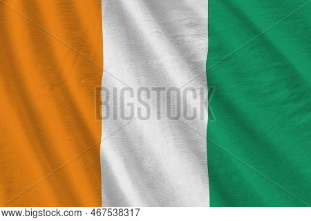 Ivory Coast Flag With Big Folds Waving Close Up Under The Studio Light Indoors. The Official Symbols
