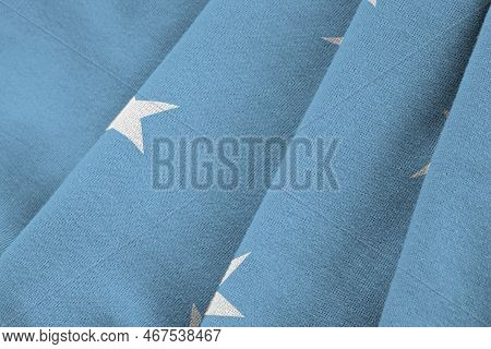 Micronesia Flag With Big Folds Waving Close Up Under The Studio Light Indoors. The Official Symbols 