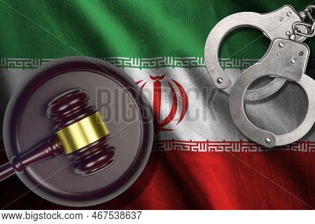 Iran Flag With Judge Mallet And Handcuffs In Dark Room. Concept Of Criminal And Punishment, Backgrou
