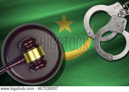 Mauritania Flag With Judge Mallet And Handcuffs In Dark Room. Concept Of Criminal And Punishment, Ba