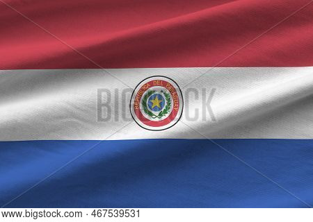 Paraguay Flag With Big Folds Waving Close Up Under The Studio Light Indoors. The Official Symbols An