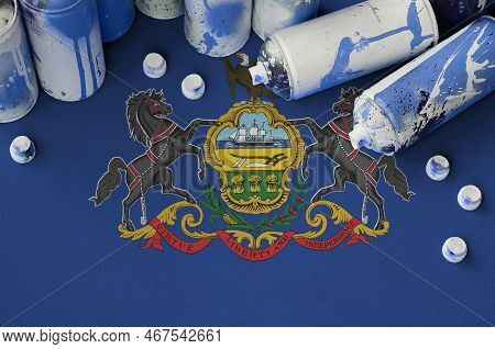 Pennsylvania Us State Flag And Few Used Aerosol Spray Cans For Graffiti Painting. Street Art Culture