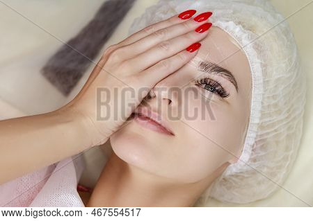 Permanent Make-up For Eyebrows Of Beautiful Woman In Beauty Salon While Woman Laying With One Eye Cl