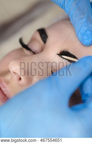 Microblading, Micropigmentation Eyebrows Work Flow In A Beauty Salon. Woman Having Her Eye Brows Dra